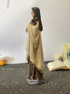 Hand-painted Saint Therese of Lisieux statue holding crucifix and roses