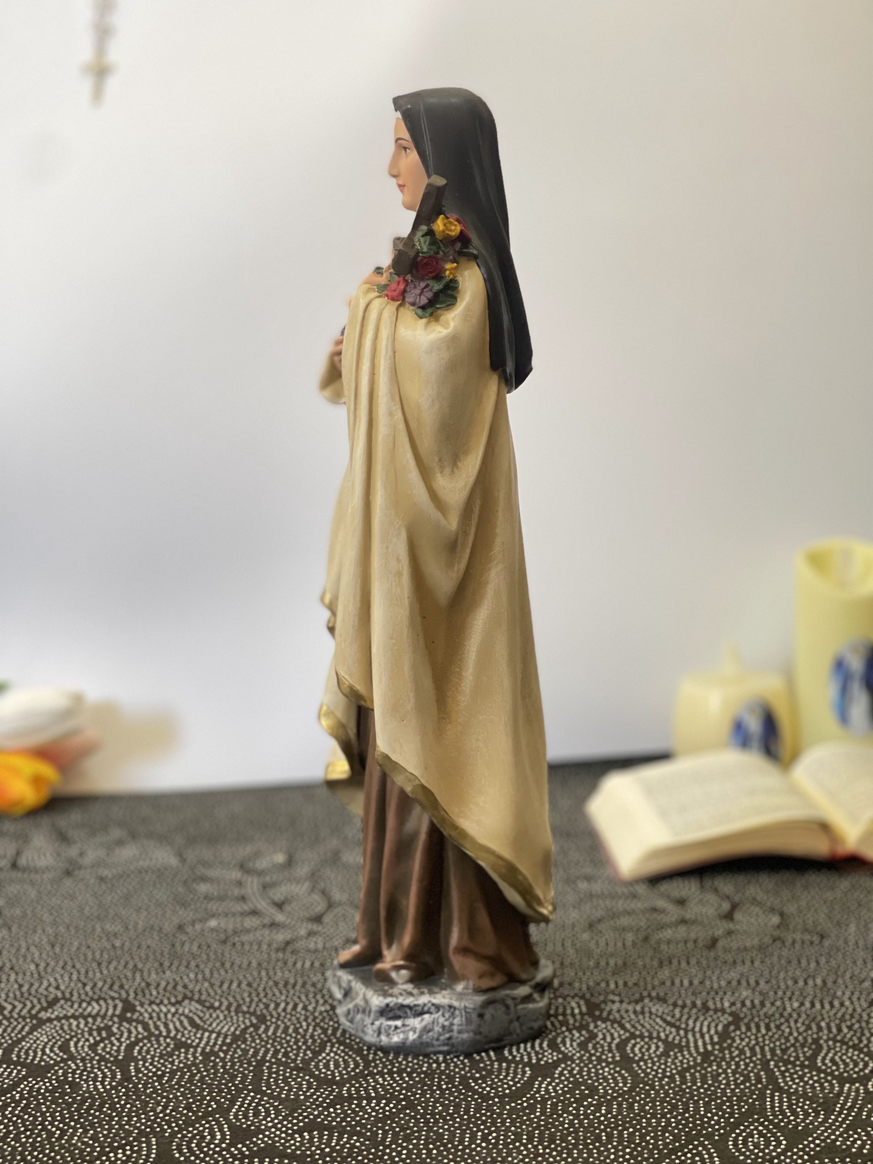 Hand-painted Saint Therese of Lisieux statue holding crucifix and roses