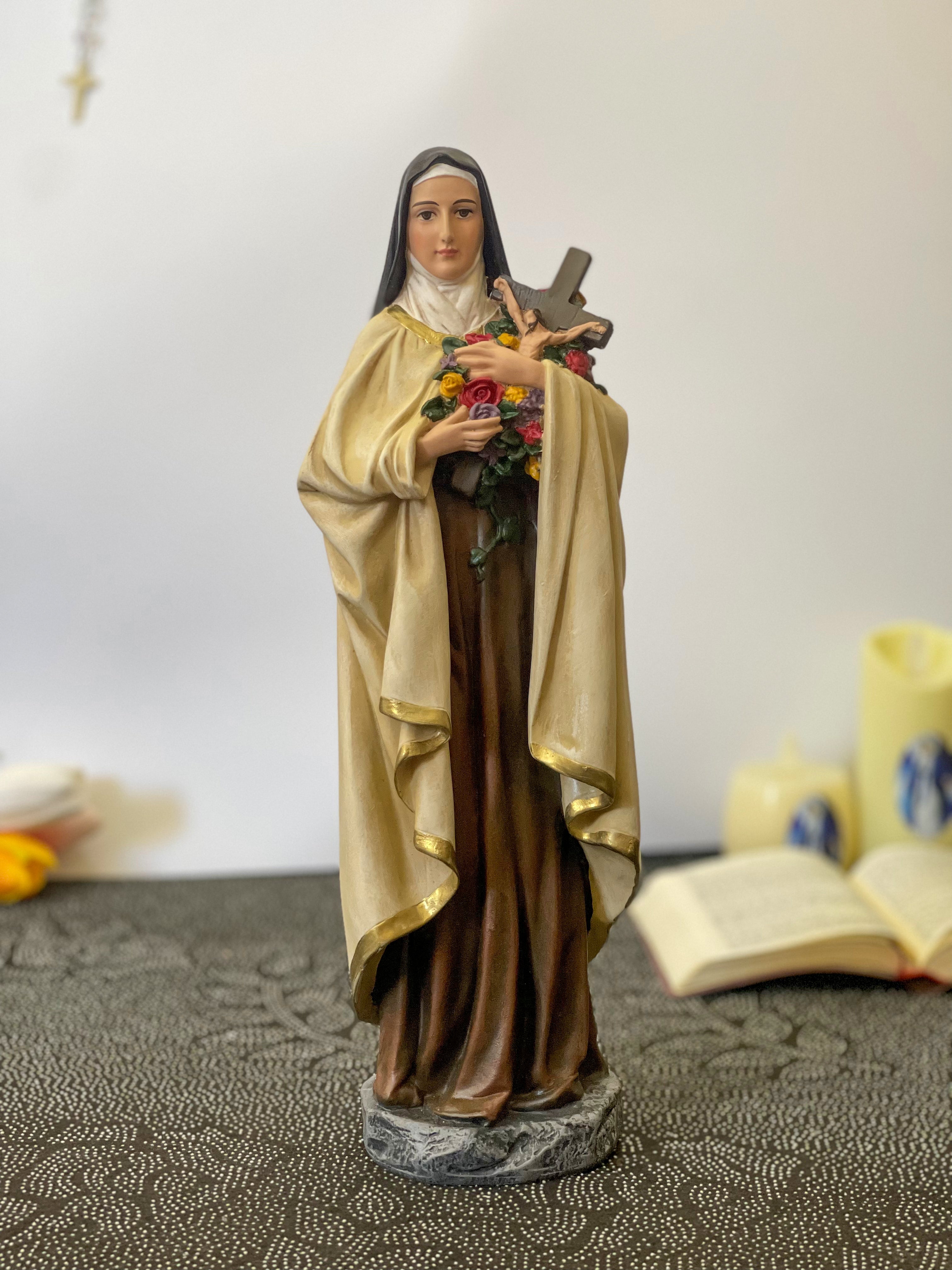 Hand-painted Saint Therese of Lisieux statue holding crucifix and roses