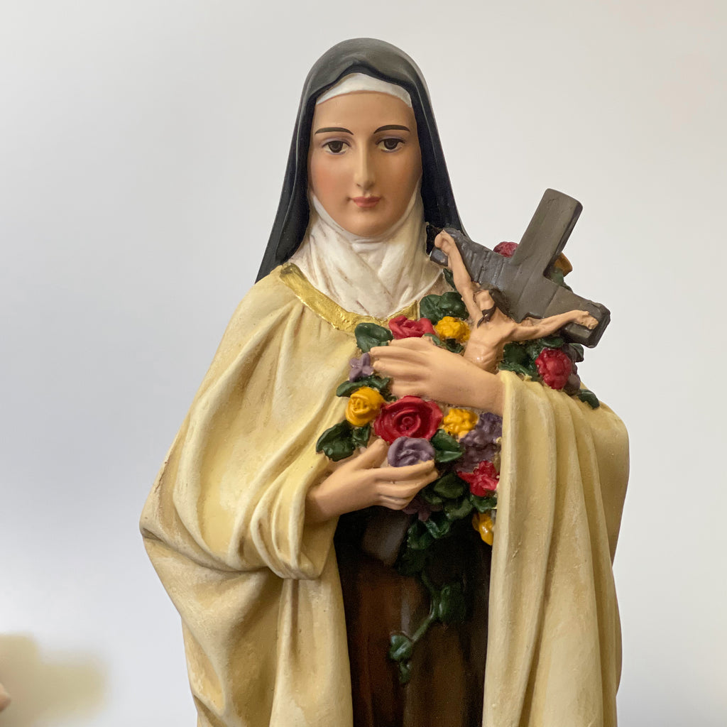 Hand-painted Saint Therese of Lisieux statue holding crucifix and roses